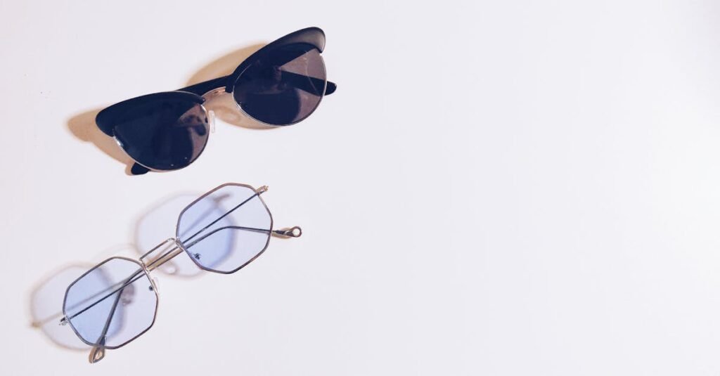 Flat lay of sunglasses and eyeglasses on a white background, perfect for fashion design concepts.